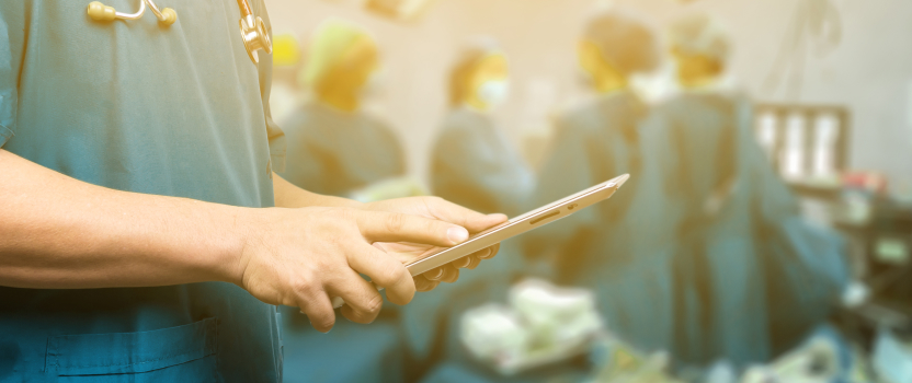 Healthcare professional reviewing patient information on a clipboard